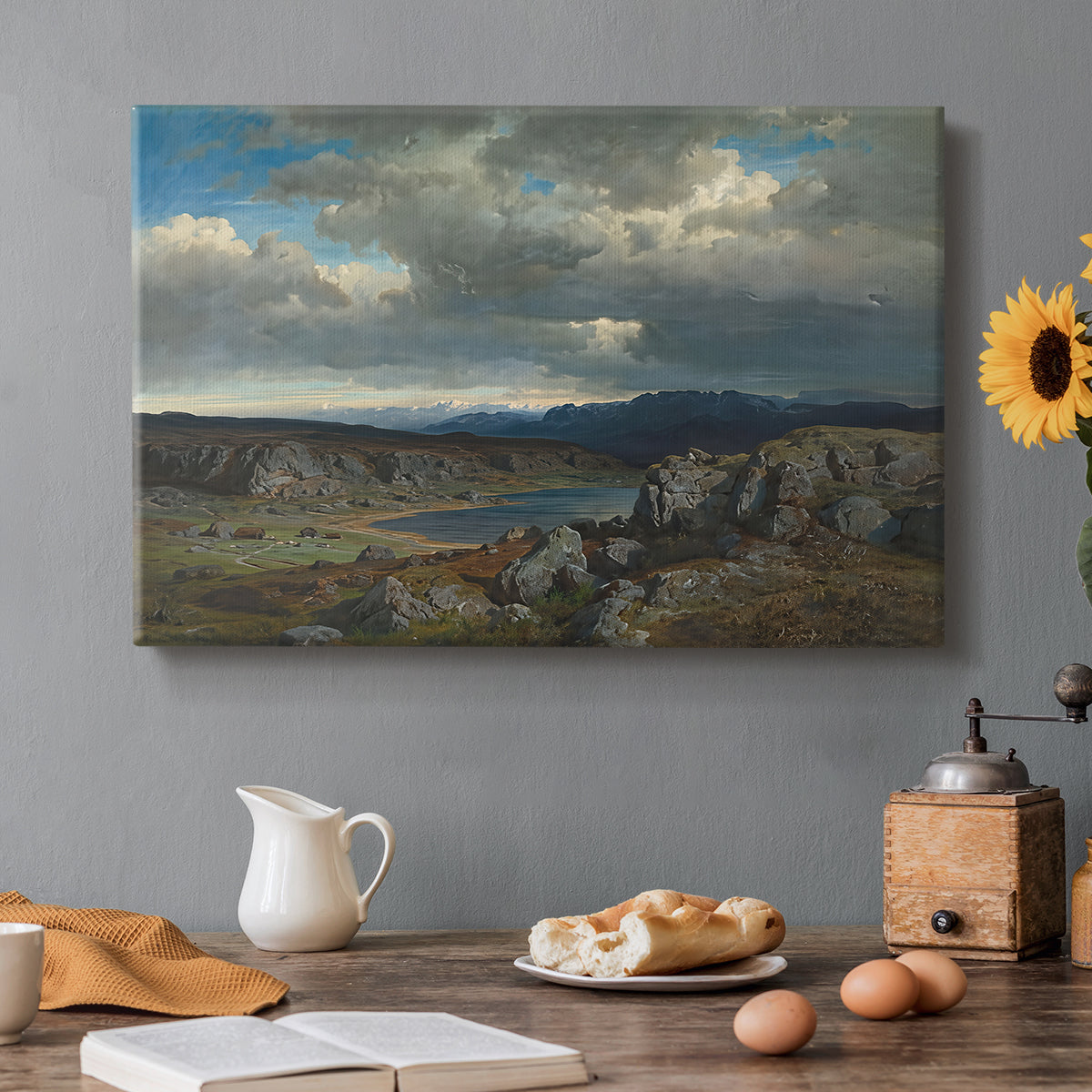 Canvas art print featuring a rugged highland landscape with mountains and open terrain, set in a cozy kitchen setting