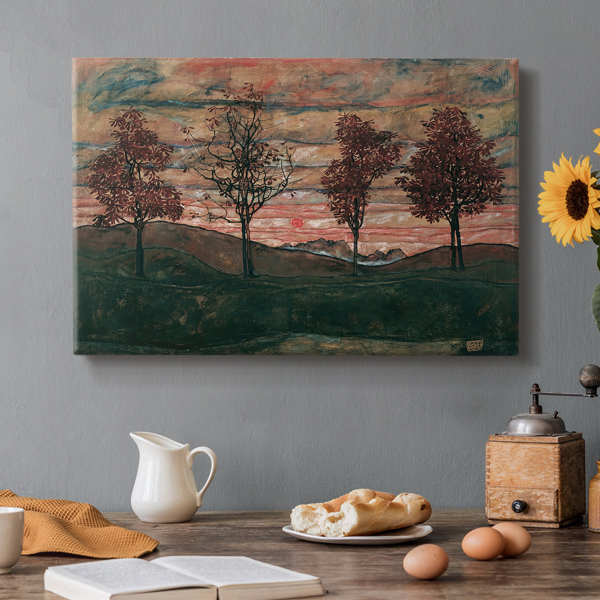Canvas art print featuring four trees standing in open landscape against colorful sky, set in a cozy kitchen setting