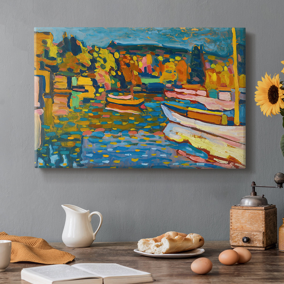 Canvas art print featuring a semi-abstract landscape with boats and shoreline suggested through bold color areas, set in a cozy kitchen setting