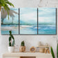 Three-panel canvas wall art featuring sunset silhouette over coastal water, displayed in a boho-chic entryway above a console table.