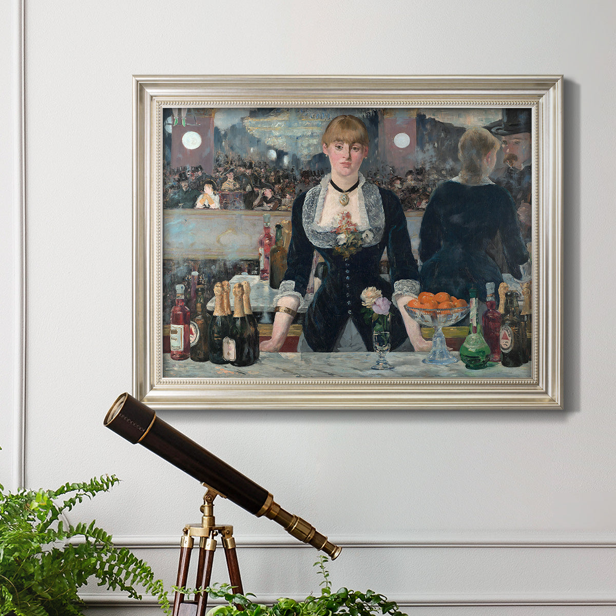 Iconic impressionist café bar scene by Édouard Manet in an ornate champagne frame displayed in a light-toned interior setting.