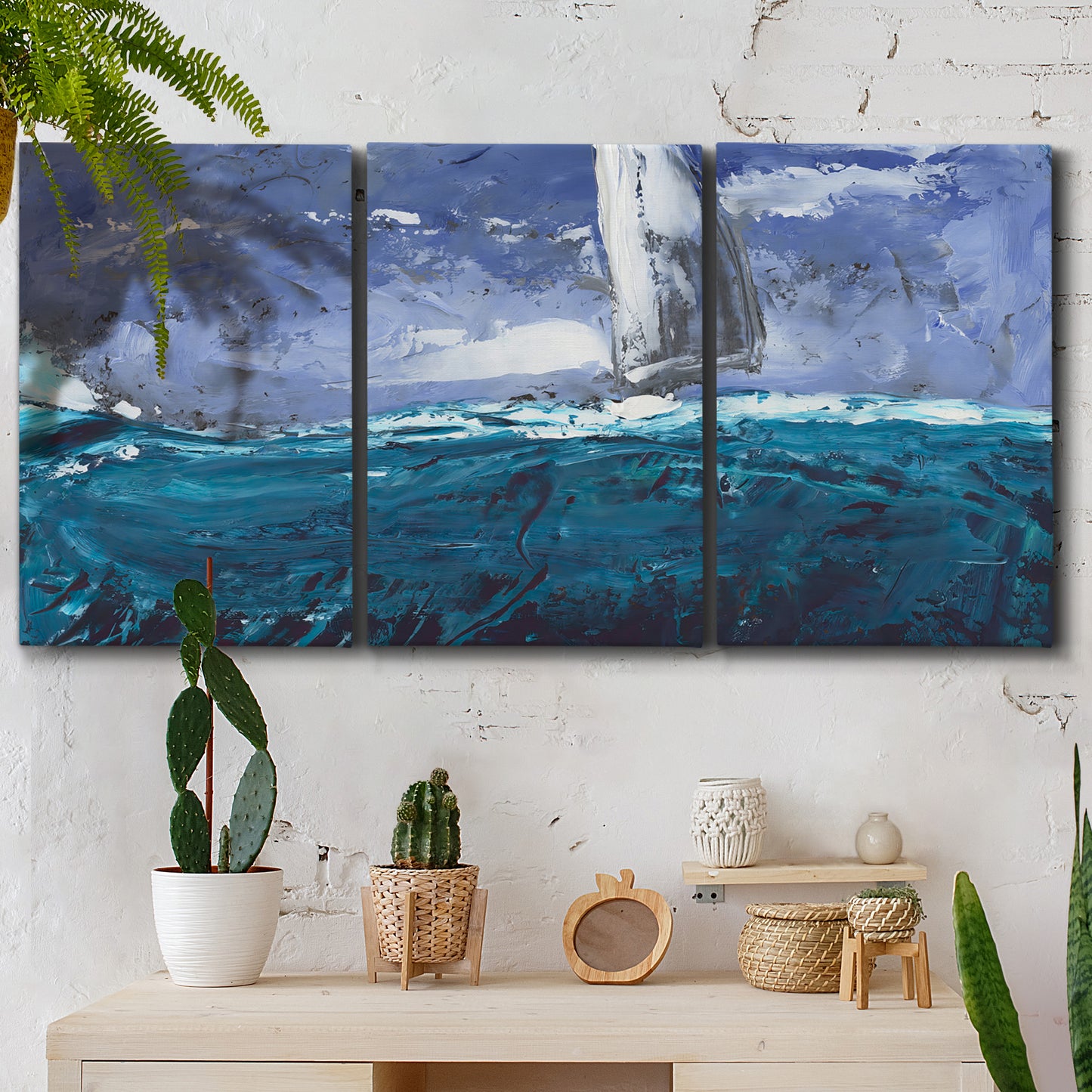 Three-panel canvas wall art featuring sailboats moving across water, displayed in a boho-chic entryway above a console table.