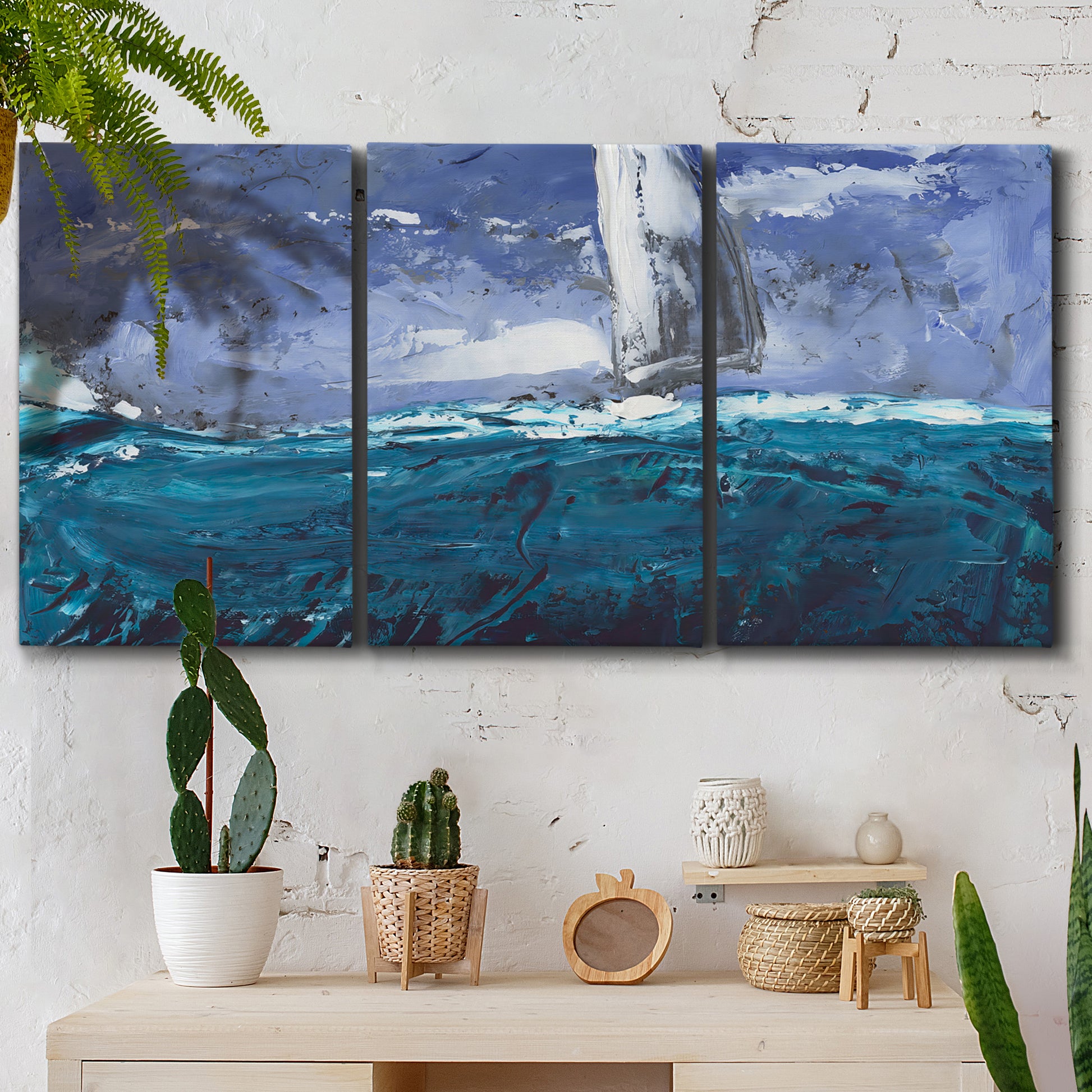 Three-panel canvas wall art featuring sailboats moving across water, displayed in a boho-chic entryway above a console table.