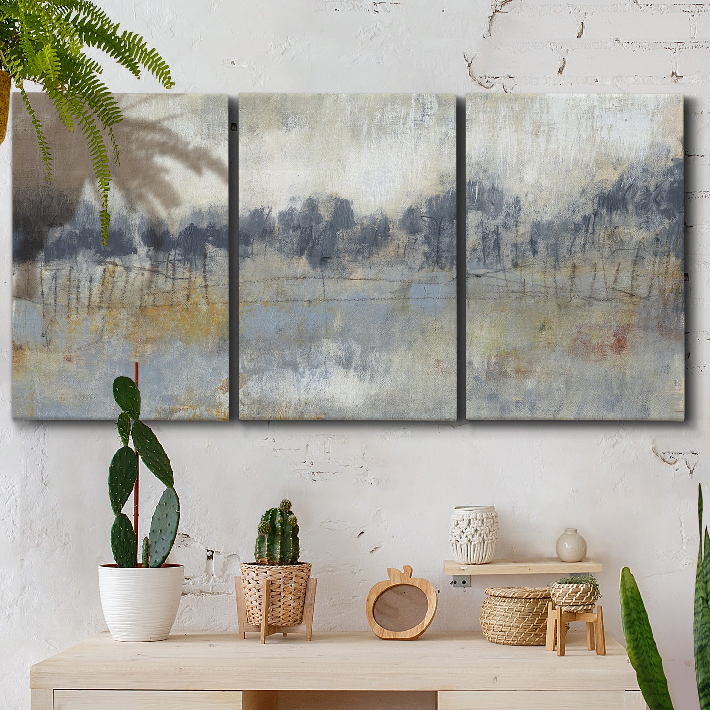 Three-panel canvas wall art featuring soft grey abstract horizon, displayed in a boho-chic entryway above a console table.