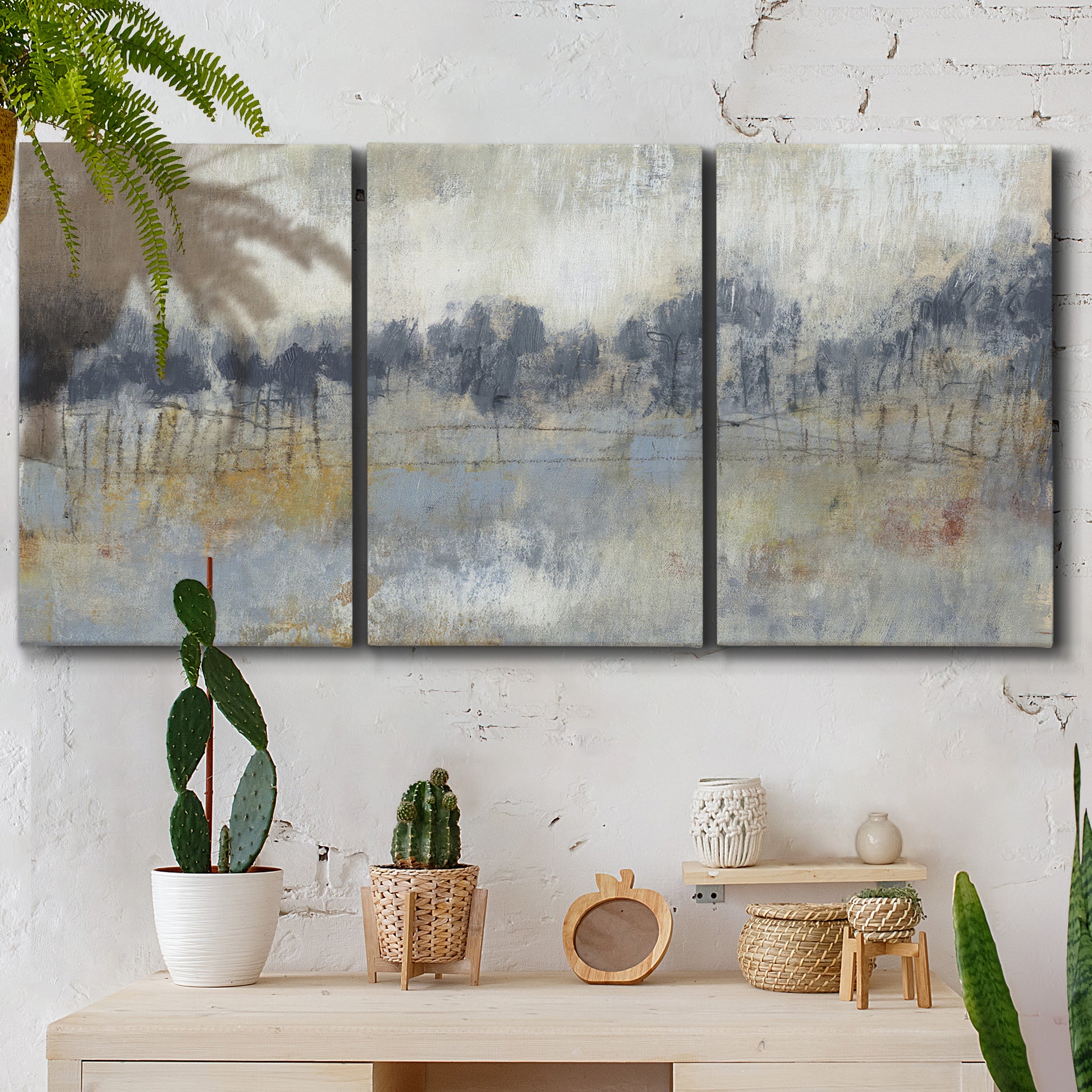 Three-panel canvas wall art featuring soft grey abstract horizon, displayed in a boho-chic entryway above a console table.
