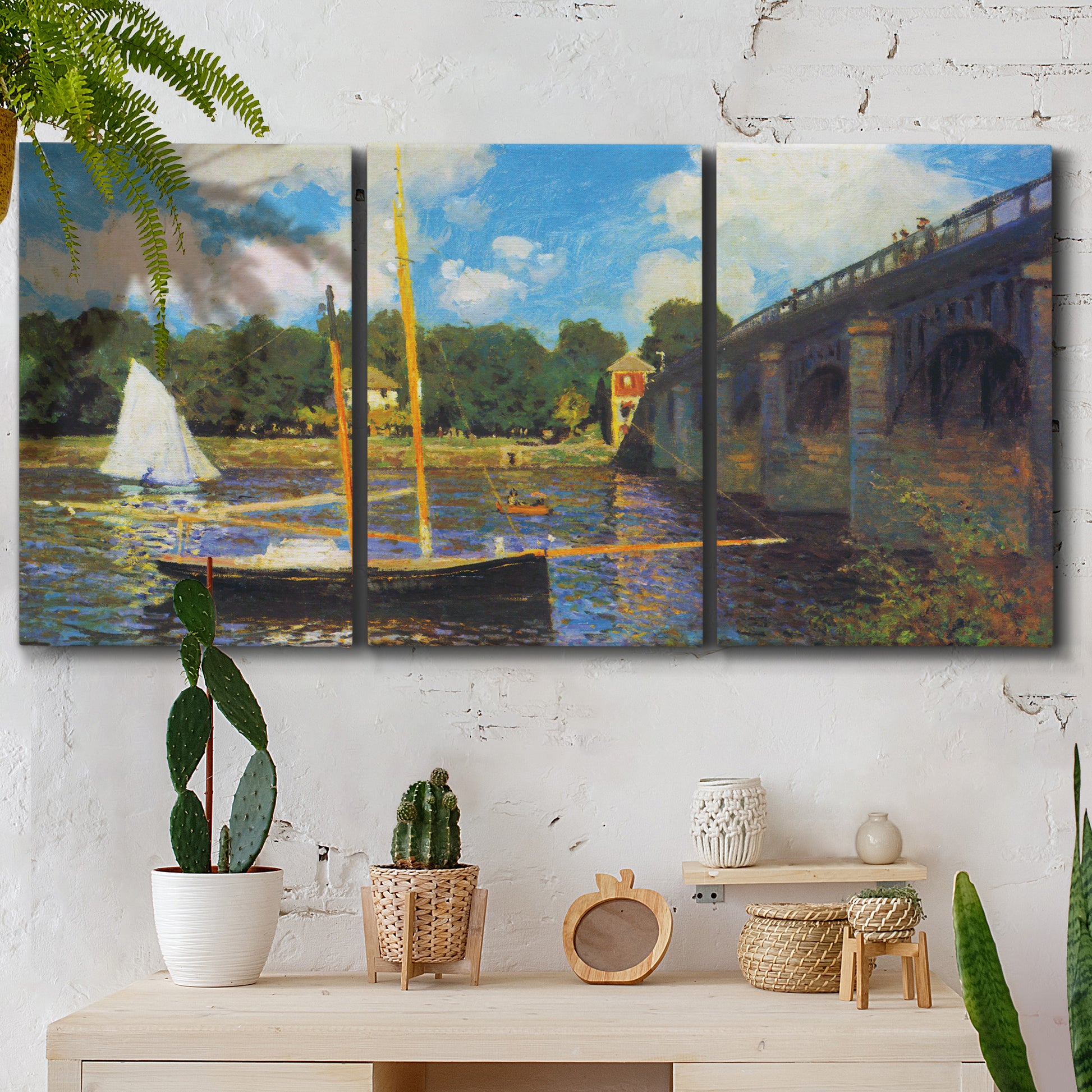 Three-panel canvas wall art featuring bridge crossing river landscape, displayed in a boho-chic entryway above a console table.