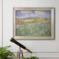 Impressionist countryside landscape near Auvers by Vincent van Gogh in an ornate champagne frame displayed in a light-toned interior setting.