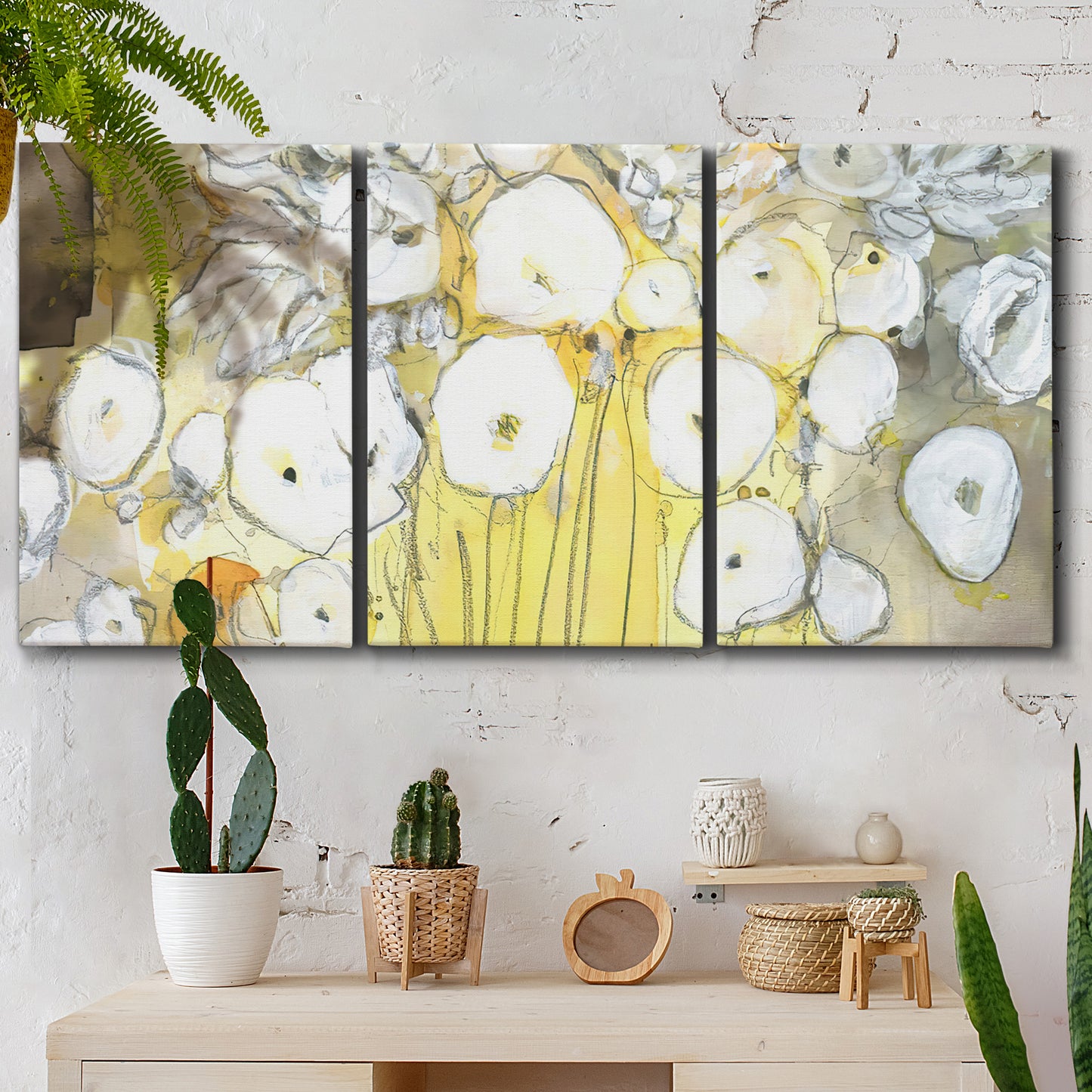 Three-panel canvas wall art featuring vintage inspired floral abstraction, displayed in a boho-chic entryway above a console table.