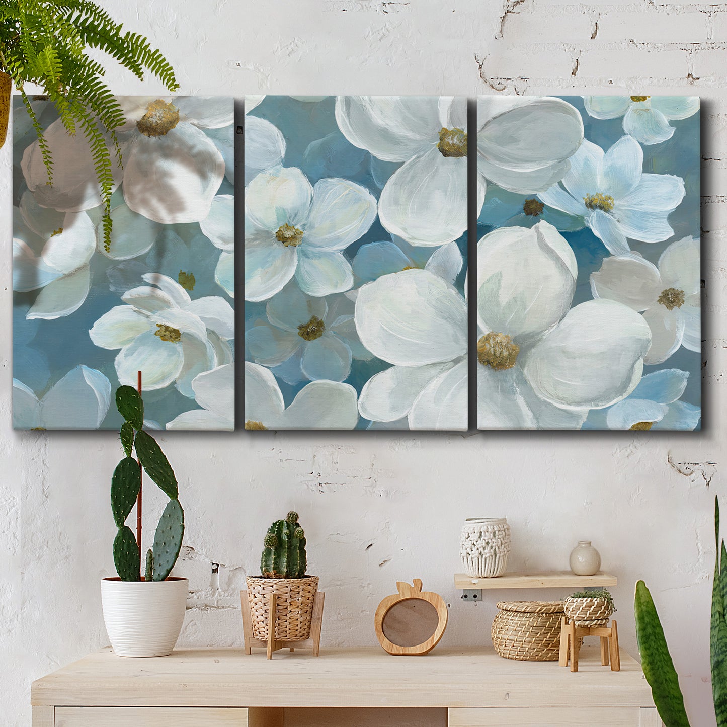 Three-panel canvas wall art featuring soft white floral abstraction, displayed in a boho-chic entryway above a console table.