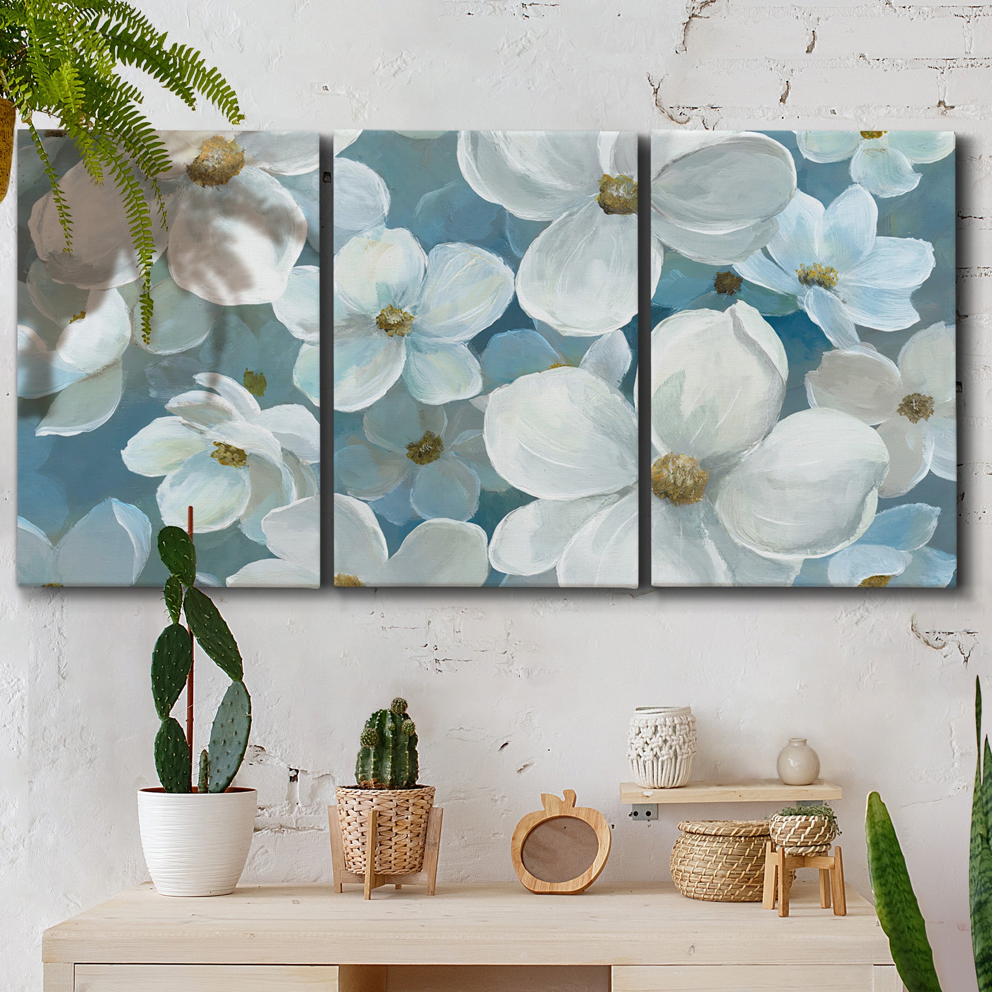 Three-panel canvas wall art featuring soft white floral abstraction, displayed in a boho-chic entryway above a console table.