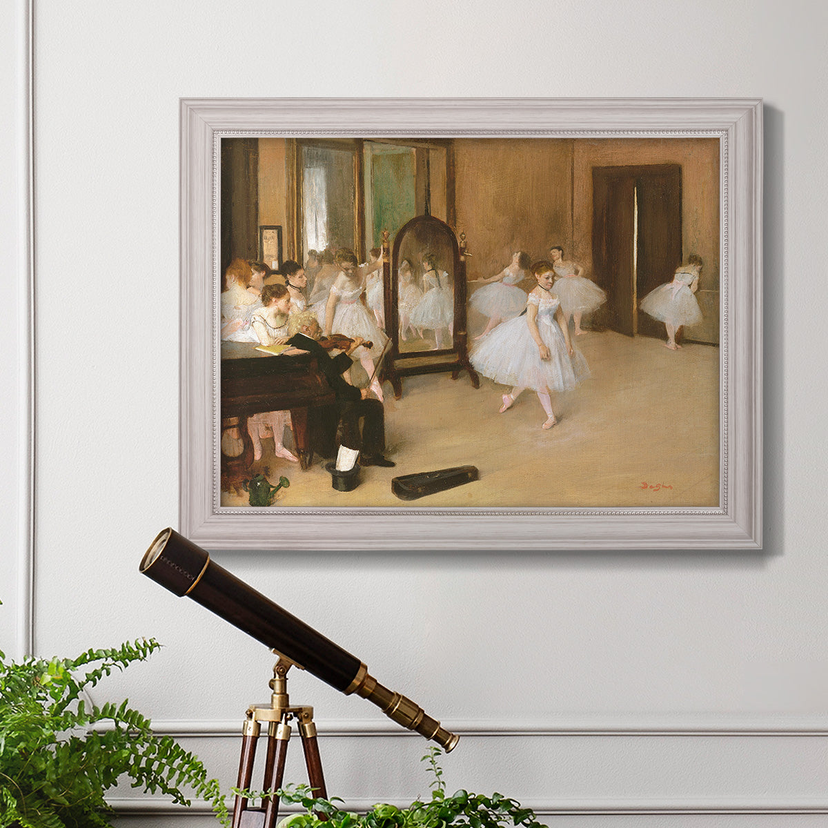 Impressionist dance class interior scene by Edgar Degas in an ornate weathered white frame displayed in a light-toned interior setting.