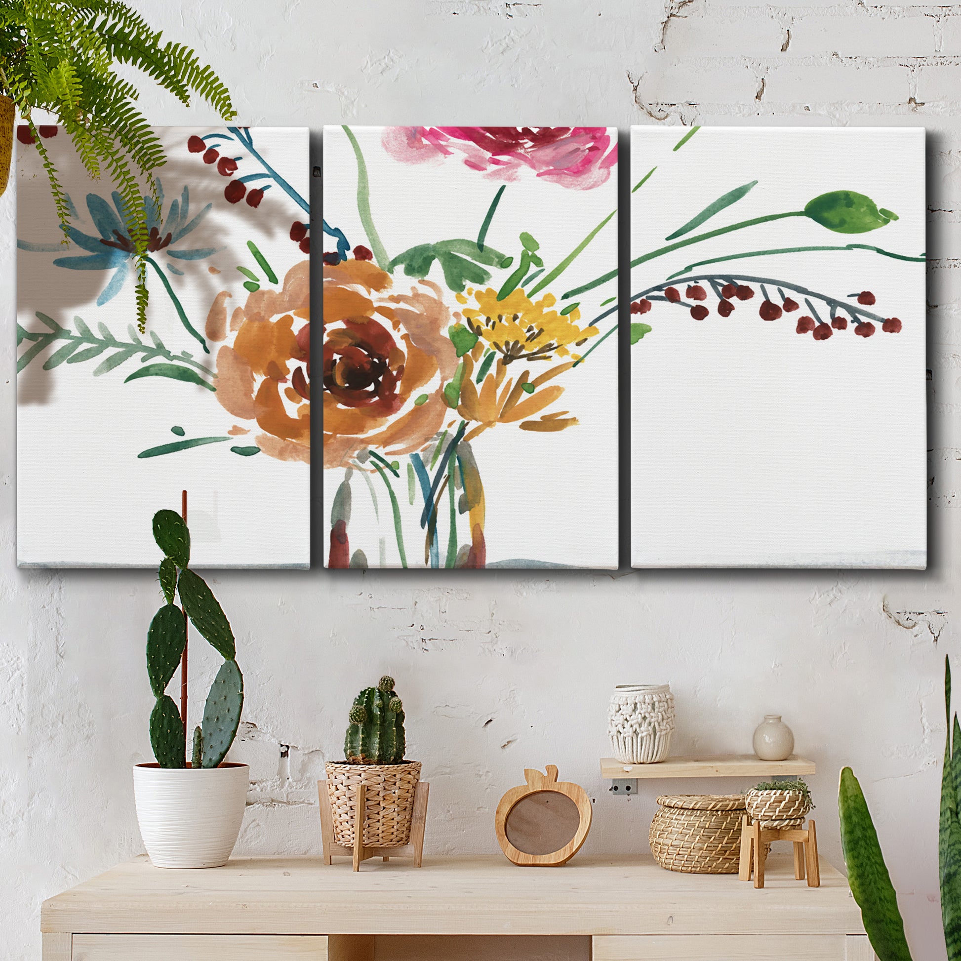 Three-panel canvas wall art featuring vibrant floral bouquet, displayed in a boho-chic entryway above a console table.