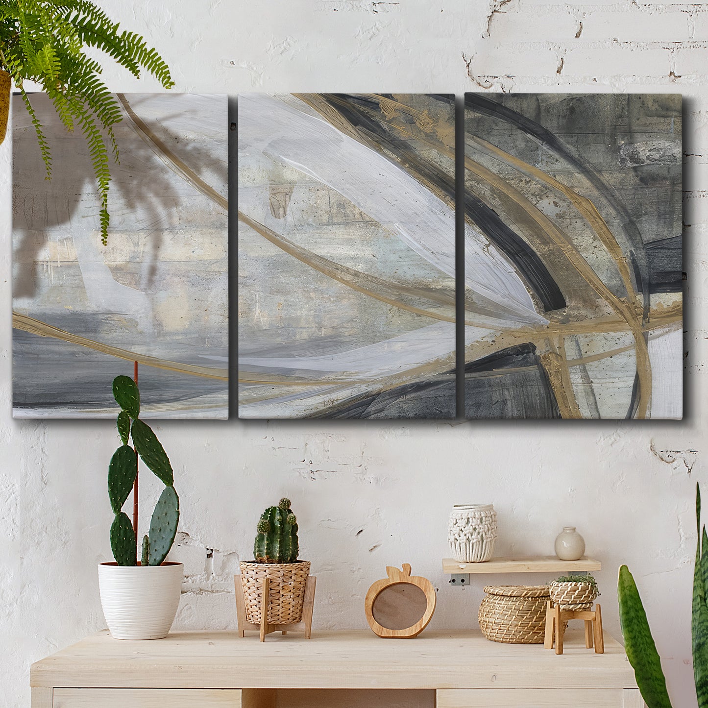 Three-panel canvas wall art featuring spiraling abstract vortex motion, displayed in a boho-chic entryway above a console table.