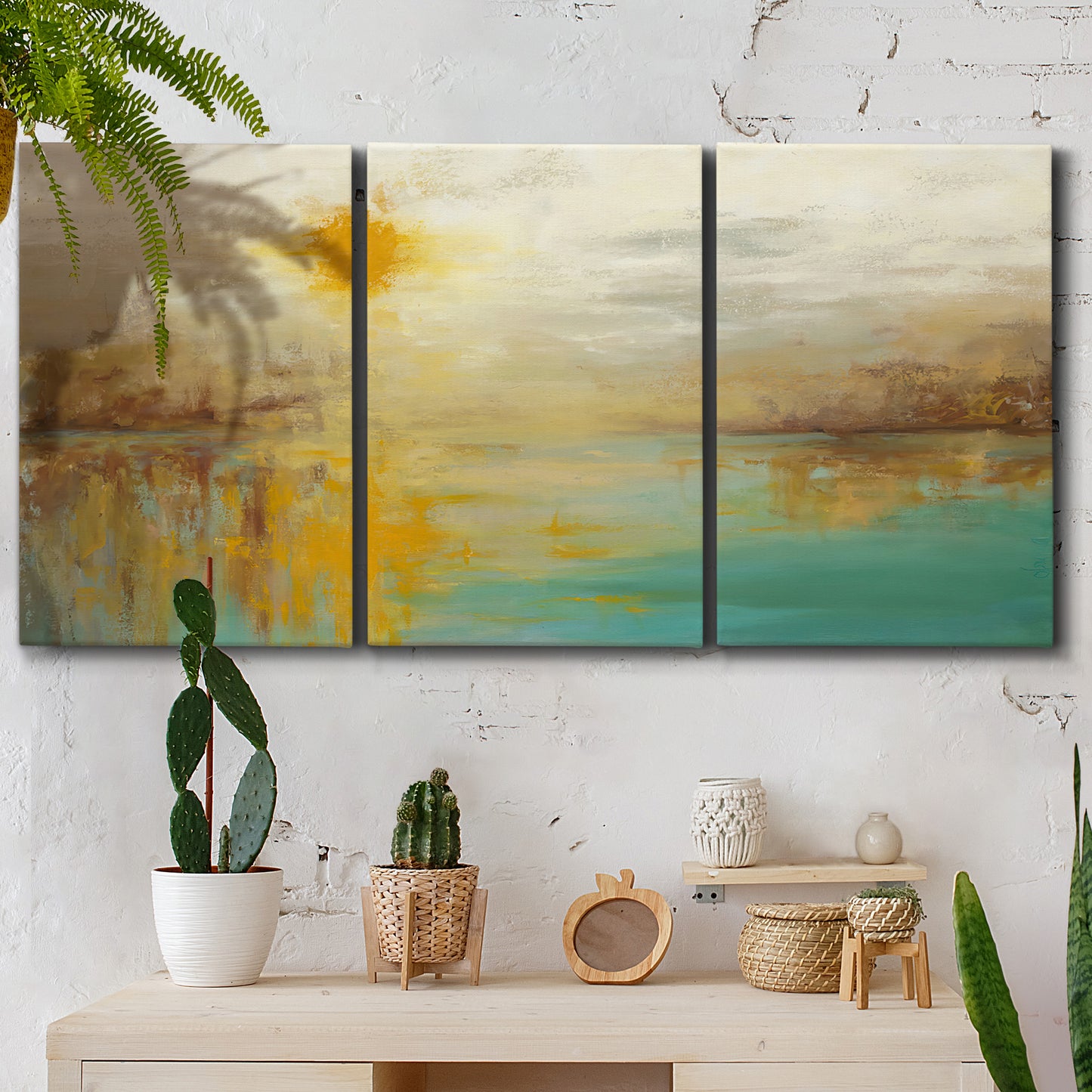 Three-panel canvas wall art featuring warm abstract end of summer palette, displayed in a boho-chic entryway above a console table.