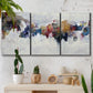 Three-panel canvas wall art featuring abstract water inspired composition, displayed in a boho-chic entryway above a console table.