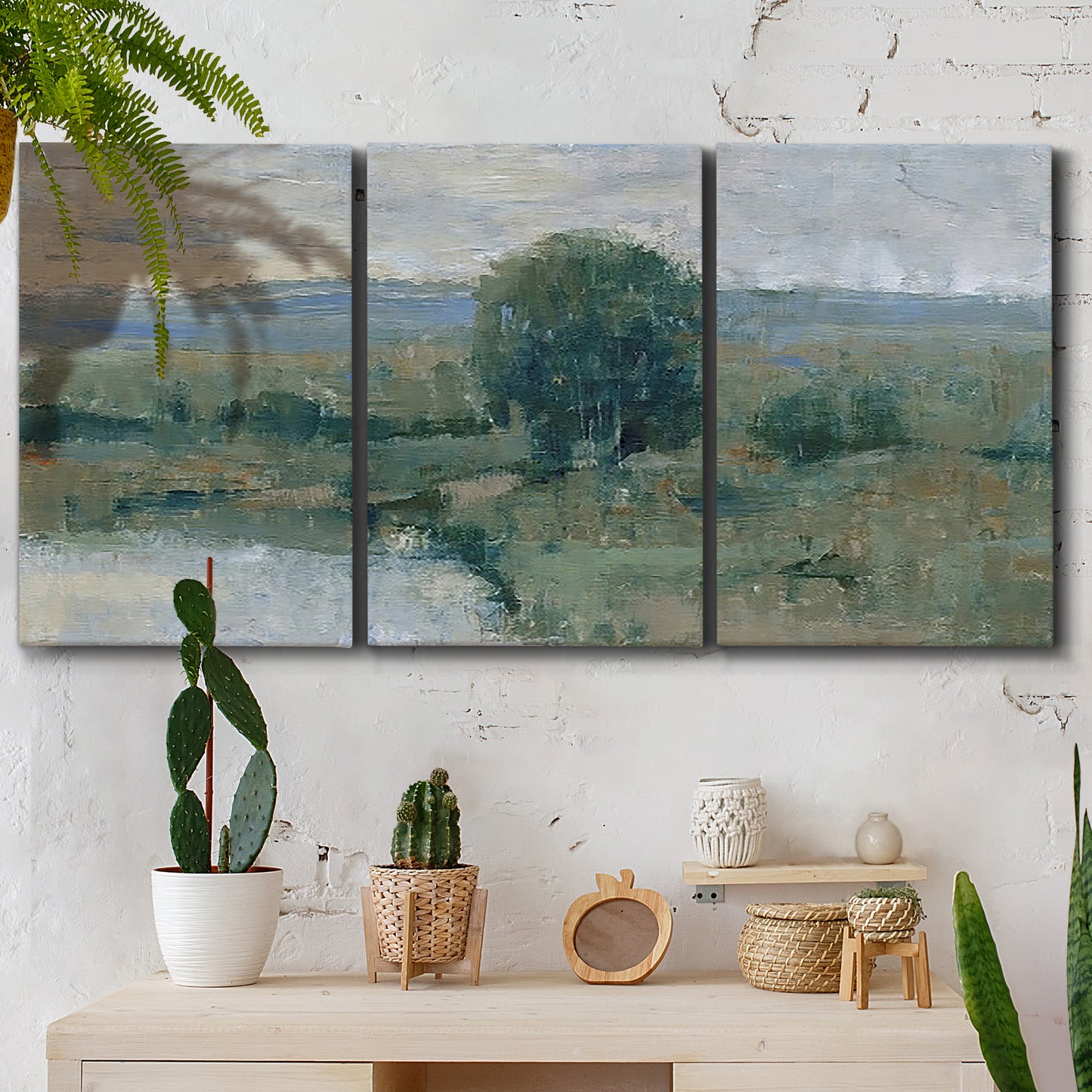 Three-panel canvas wall art featuring riverbank landscape with reflections, displayed in a boho-chic entryway above a console table.