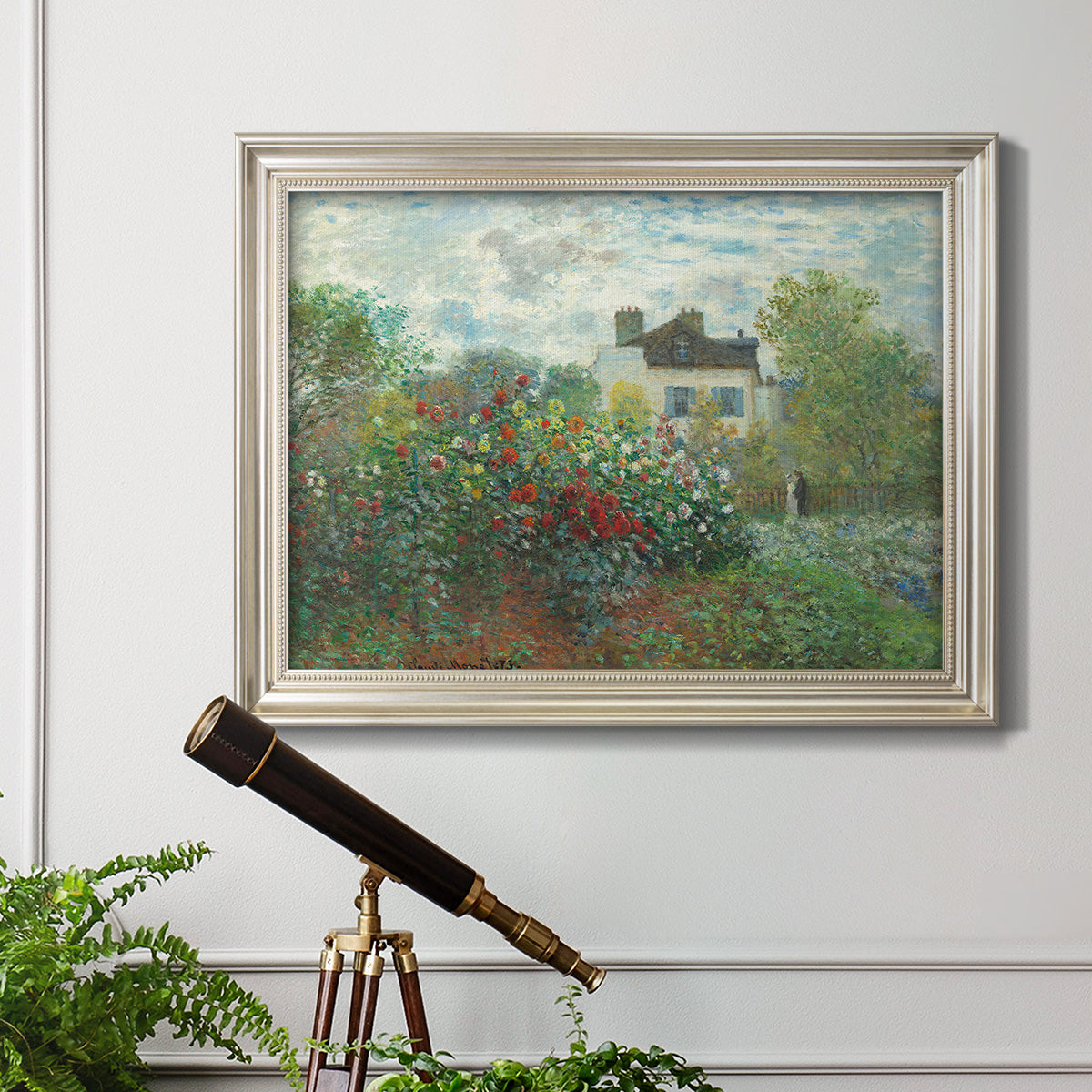 Impressionist garden landscape at Argenteuil by Claude Monet in an ornate champagne frame displayed in a light-toned interior setting.