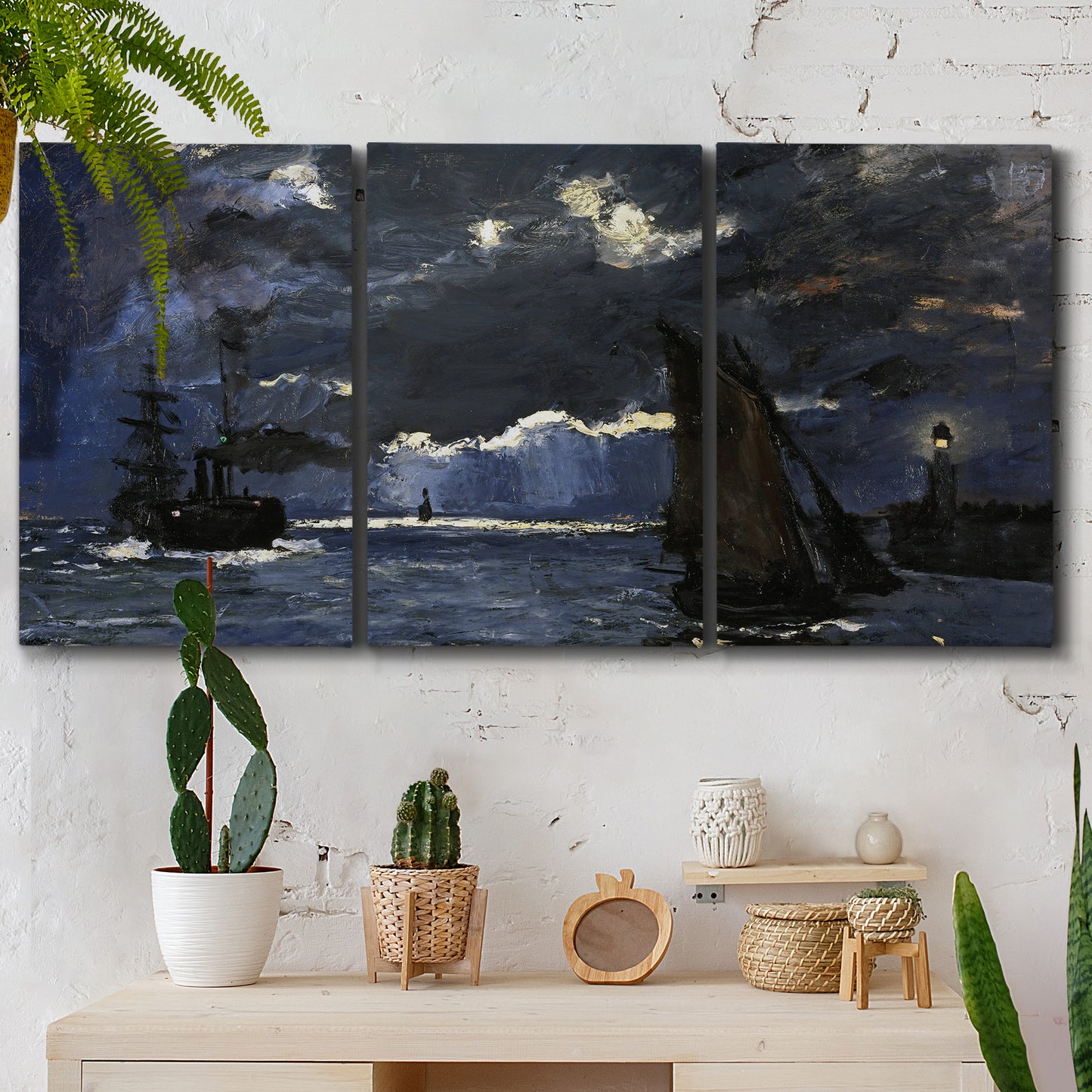 Three-panel canvas wall art featuring dark seascape under night sky, displayed in a boho-chic entryway above a console table.