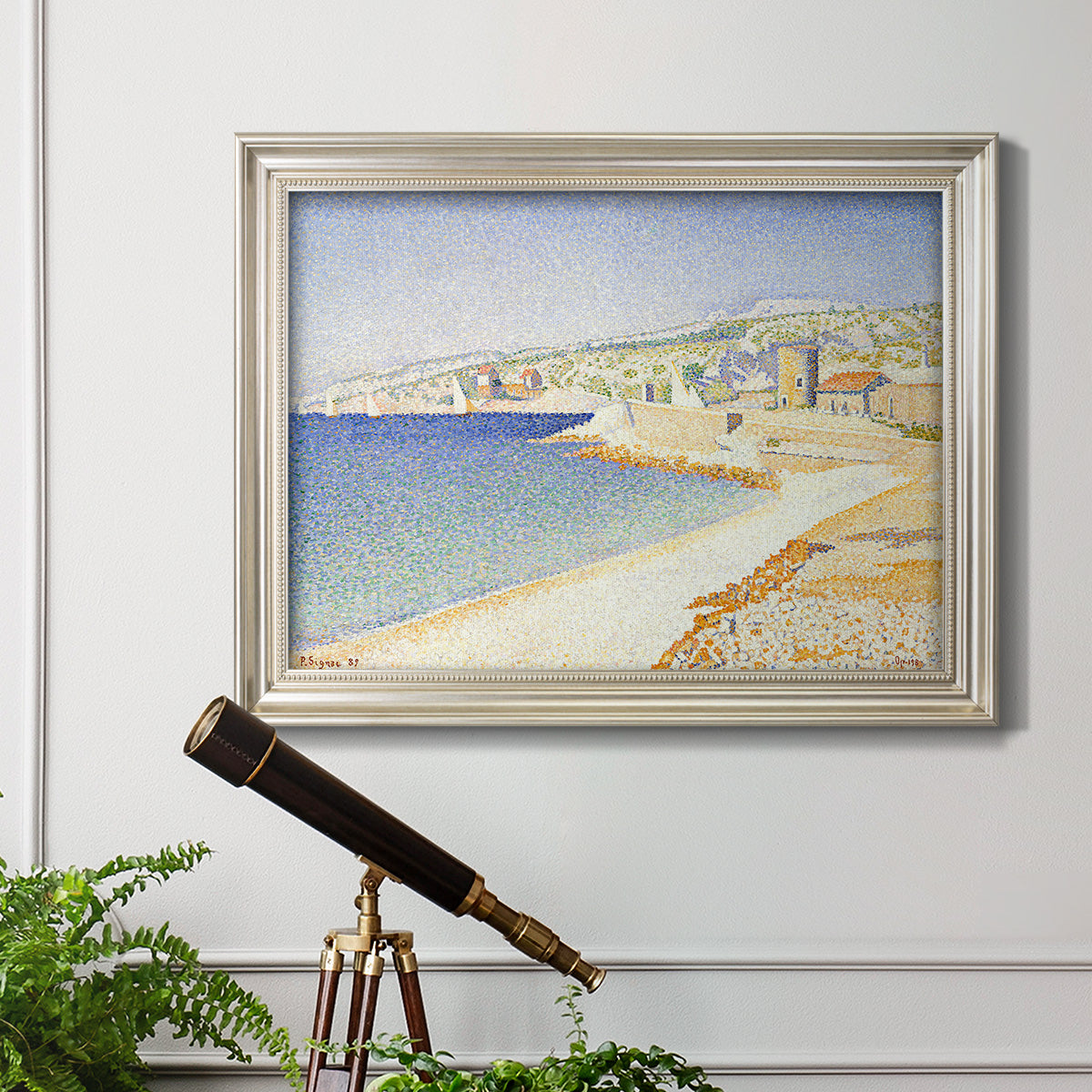 Impressionist Mediterranean jetty seascape by Paul Signac in an ornate champagne frame displayed in a light-toned interior setting.