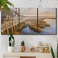Three-panel canvas wall art featuring coastal path along dunes, displayed in a boho-chic entryway above a console table.