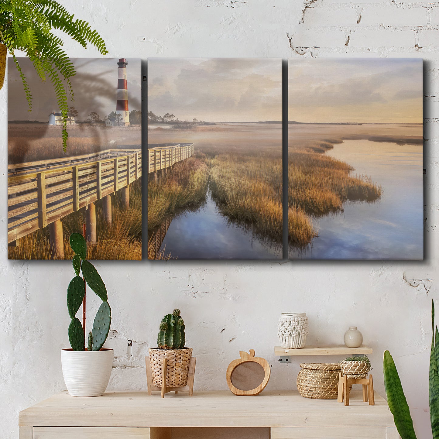 Three-panel canvas wall art featuring coastal path along dunes, displayed in a boho-chic entryway above a console table.