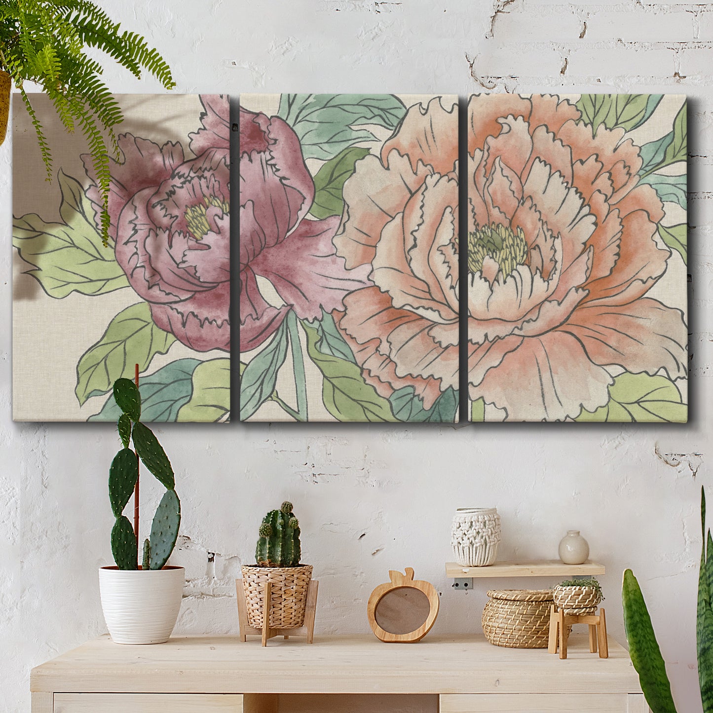 Three-panel canvas wall art featuring pastel peony flower composition, displayed in a boho-chic entryway above a console table.