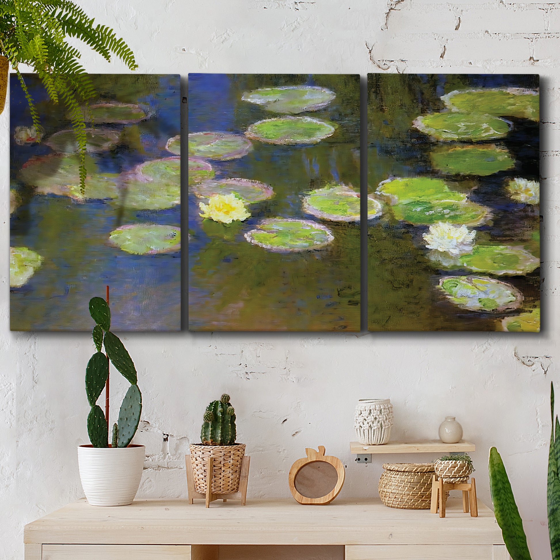 Three-panel canvas wall art featuring yellow and white water lilies, displayed in a boho-chic entryway above a console table.