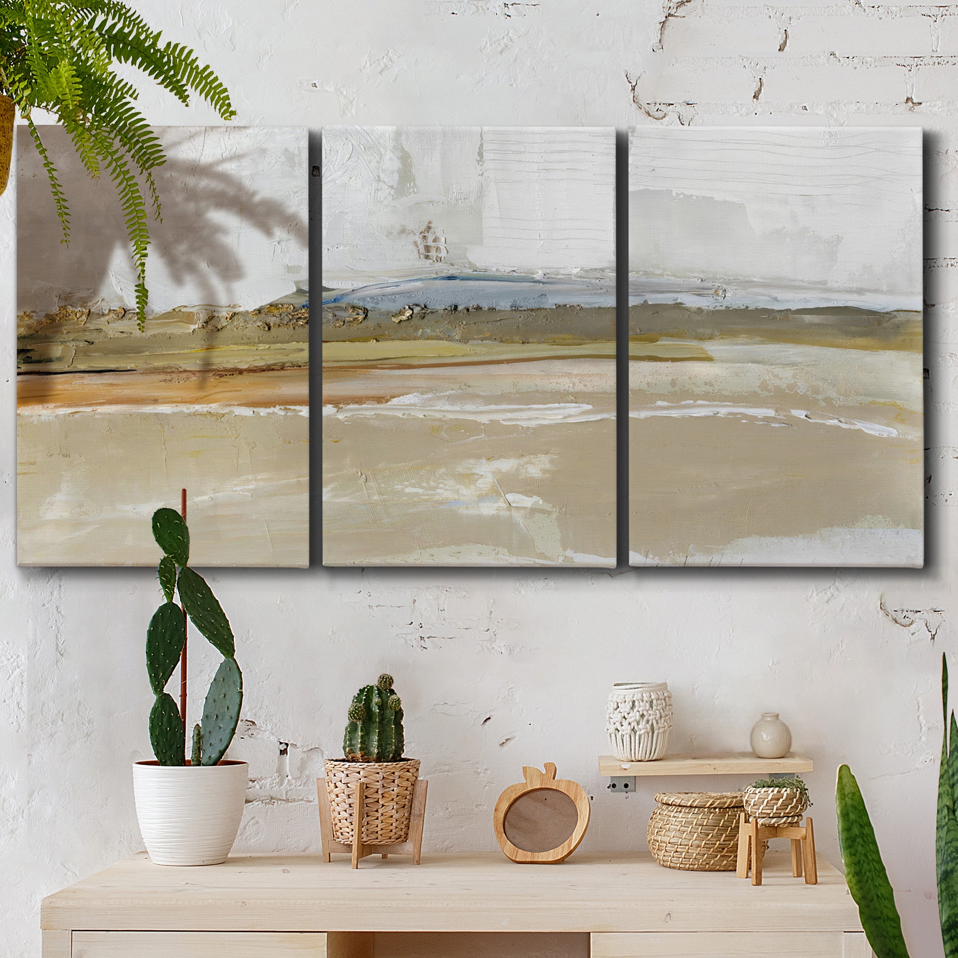 Three-panel canvas wall art featuring golden hour light over landscape, displayed in a boho-chic entryway above a console table.