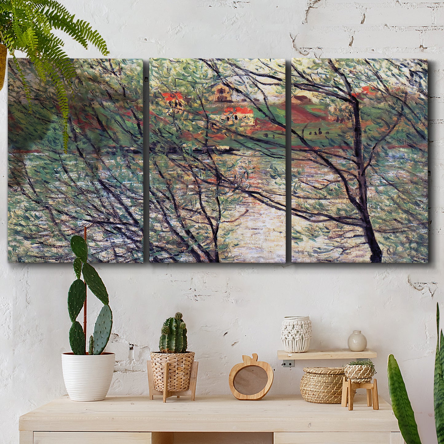 Three-panel canvas wall art featuring riverside park with figures and trees, displayed in a boho-chic entryway above a console table.