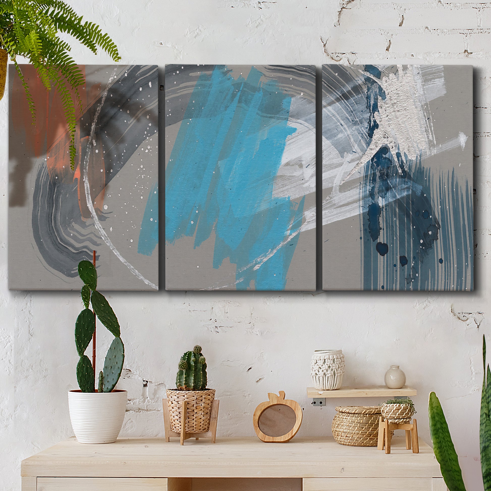 Three-panel canvas wall art featuring playful abstract mark making, displayed in a boho-chic entryway above a console table.