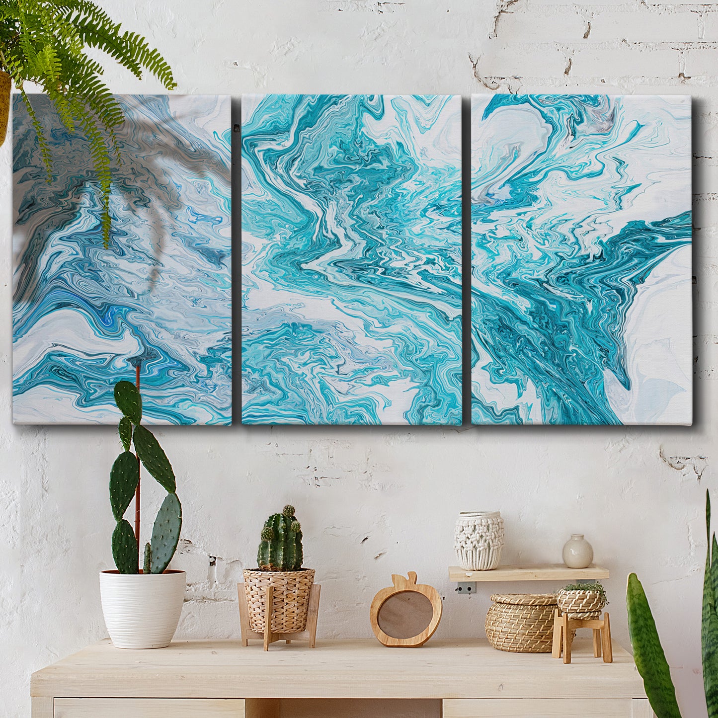 Three-panel canvas wall art featuring rocky coastal tide pool scene, displayed in a boho-chic entryway above a console table.