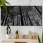 Three-panel canvas wall art featuring riverside houses along canal, displayed in a boho-chic entryway above a console table.