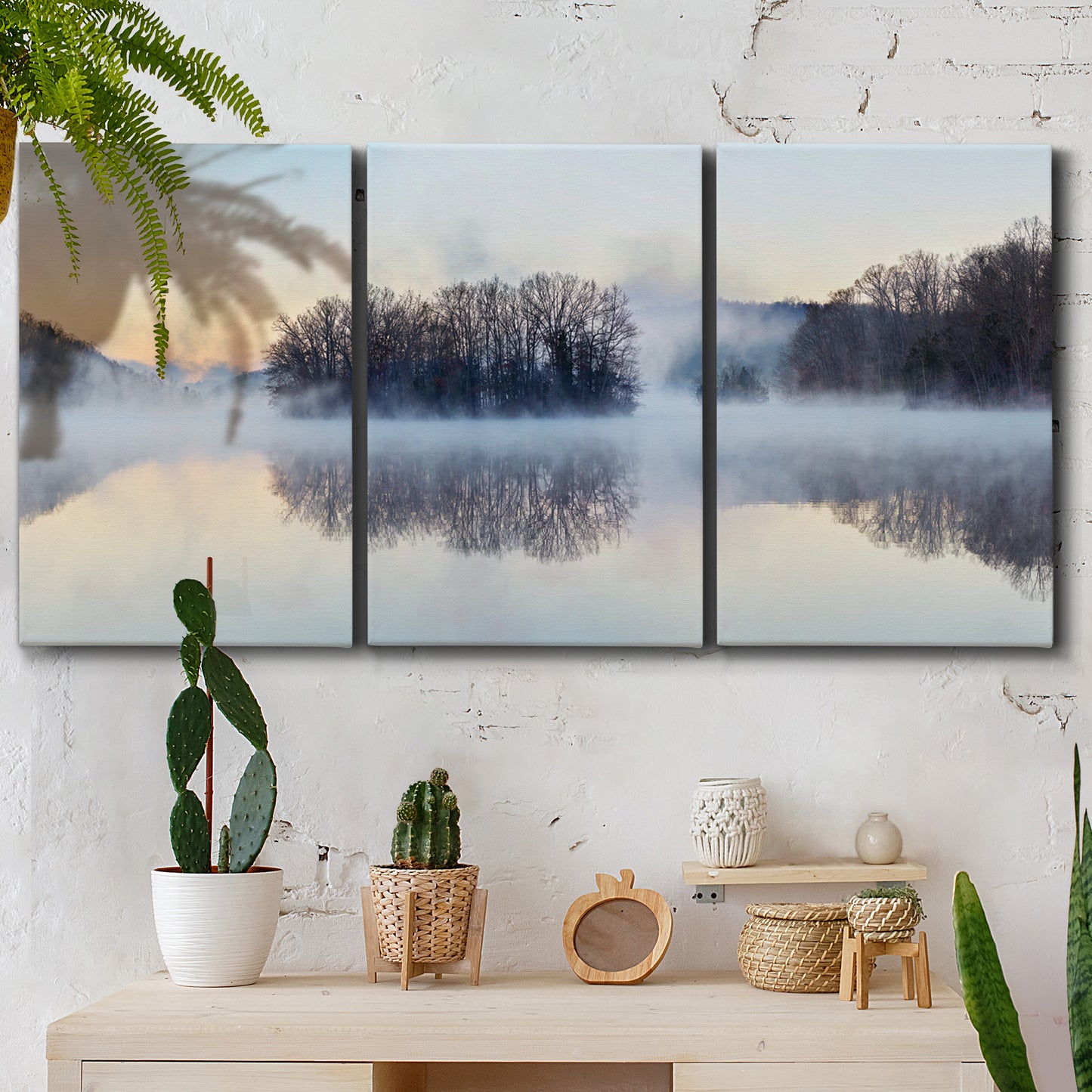 Three-panel canvas wall art featuring misty water landscape photograph, displayed in a boho-chic entryway above a console table.