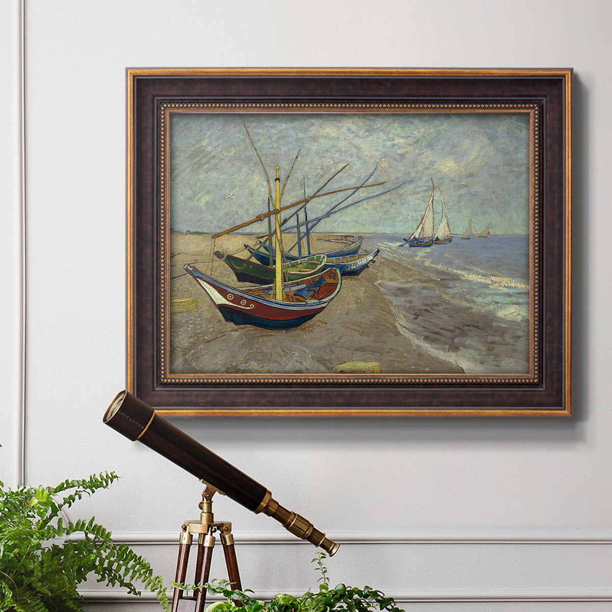 Impressionist coastal fishing boats scene by Vincent van Gogh in an ornate bronzed mahogany wood frame displayed in a light-toned interior setting.