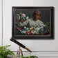 Traditional portrait of a woman holding peonies by Frédéric Bazille in an ornate black frame with gilded inner detail displayed in a light-toned interior setting.
