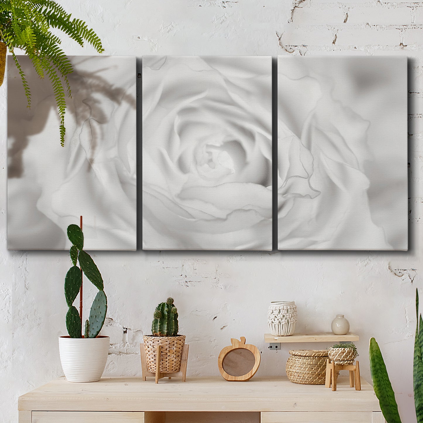 Three-panel canvas wall art featuring monochrome rose study photograph, displayed in a boho-chic entryway above a console table.