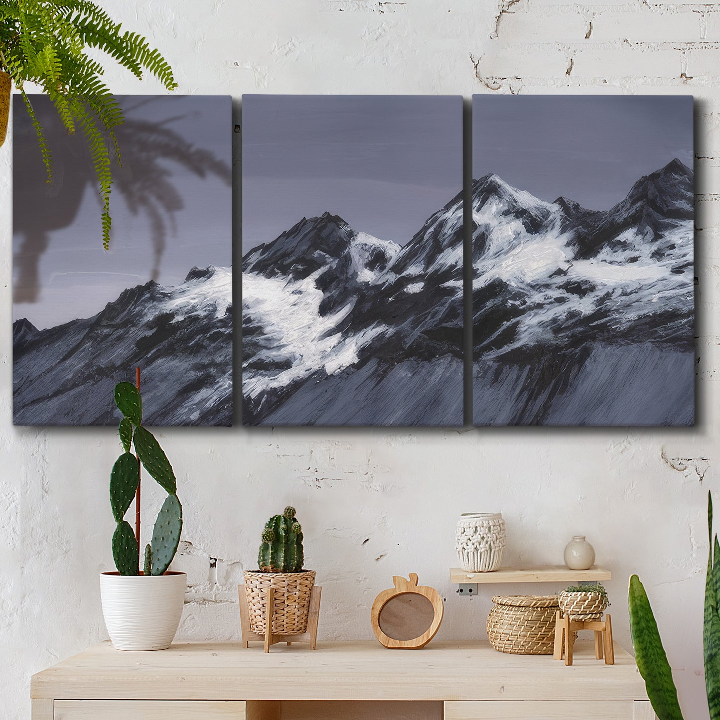 Three-panel canvas wall art featuring moonlit mountain peaks under night sky, displayed in a boho-chic entryway above a console table.