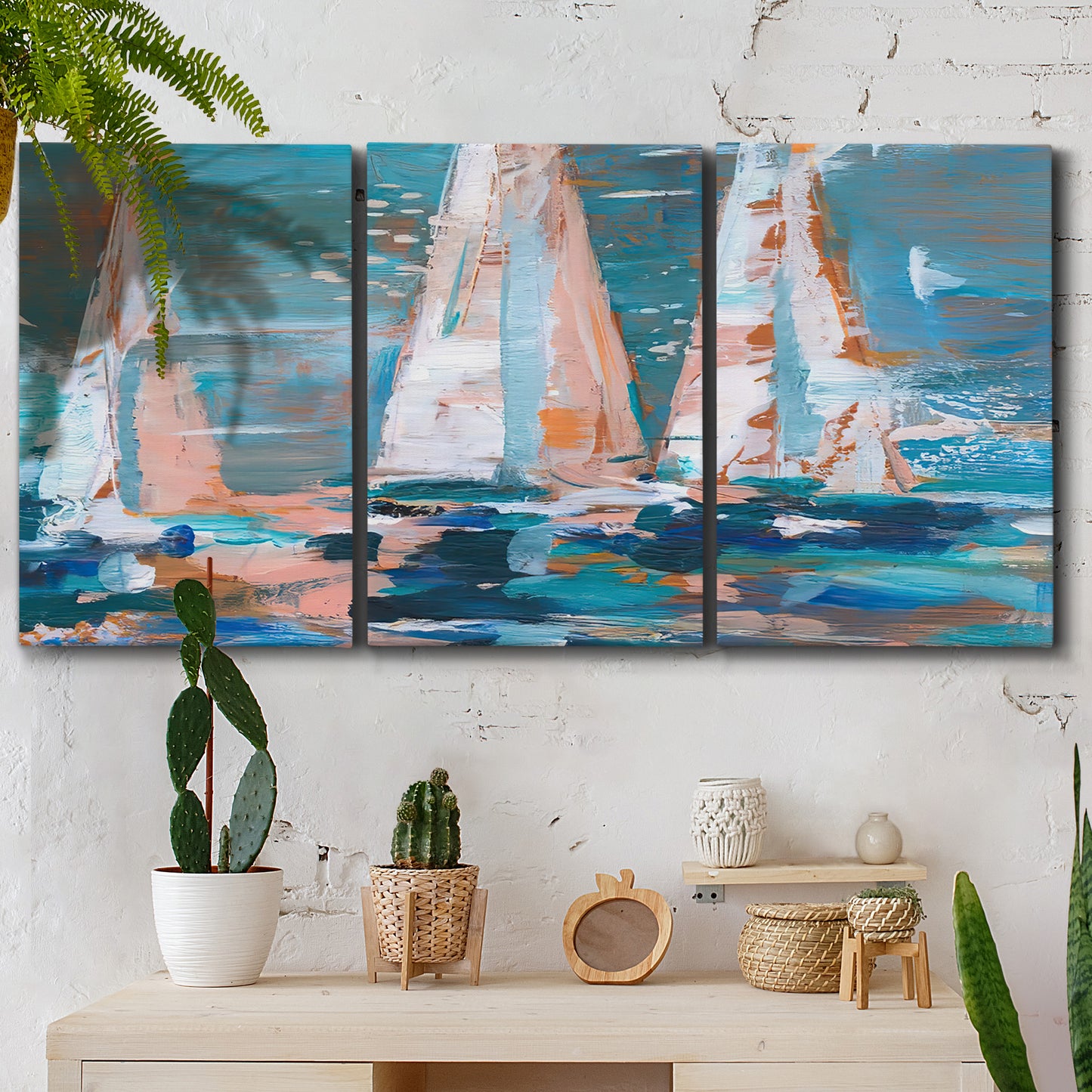 Three-panel canvas wall art featuring graphic pop style sailboats, displayed in a boho-chic entryway above a console table.
