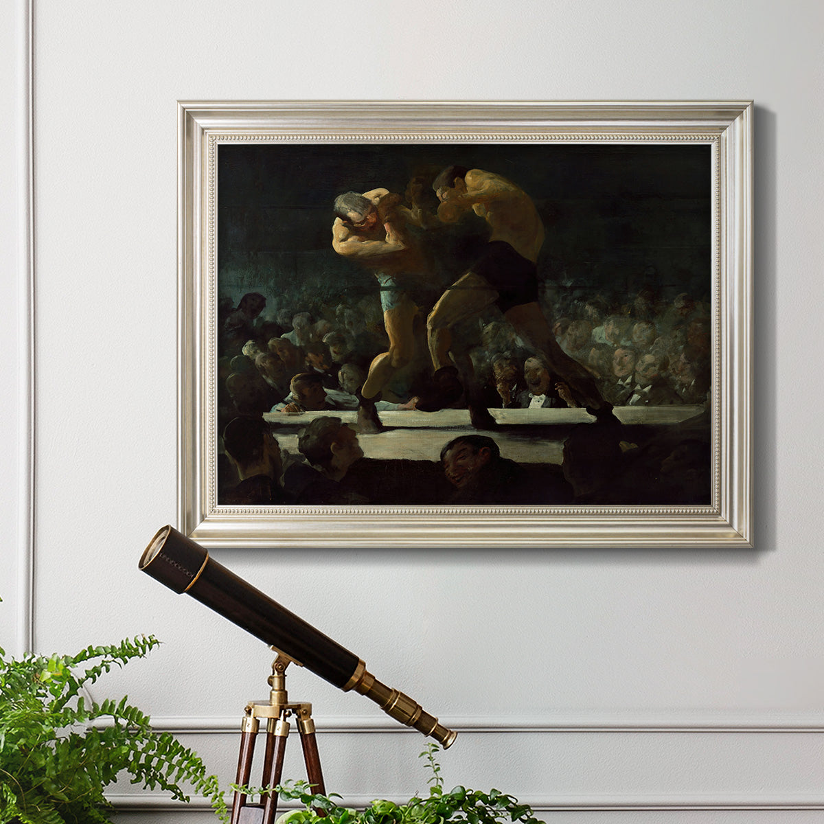 American social club scene painting by George Bellows in an ornate champagne frame displayed in a light-toned interior setting.