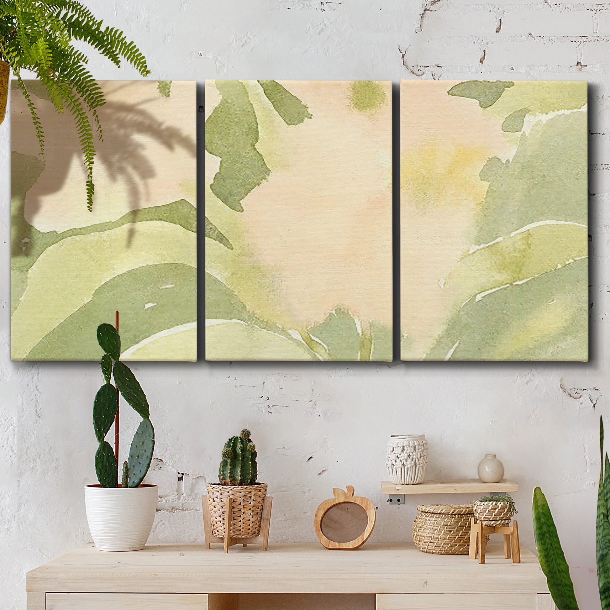 Three-panel canvas wall art featuring minimal verdant floral abstraction, displayed in a boho-chic entryway above a console table.