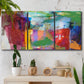 Three-panel canvas wall art featuring vibrant abstract color field panels, displayed in a boho-chic entryway above a console table.