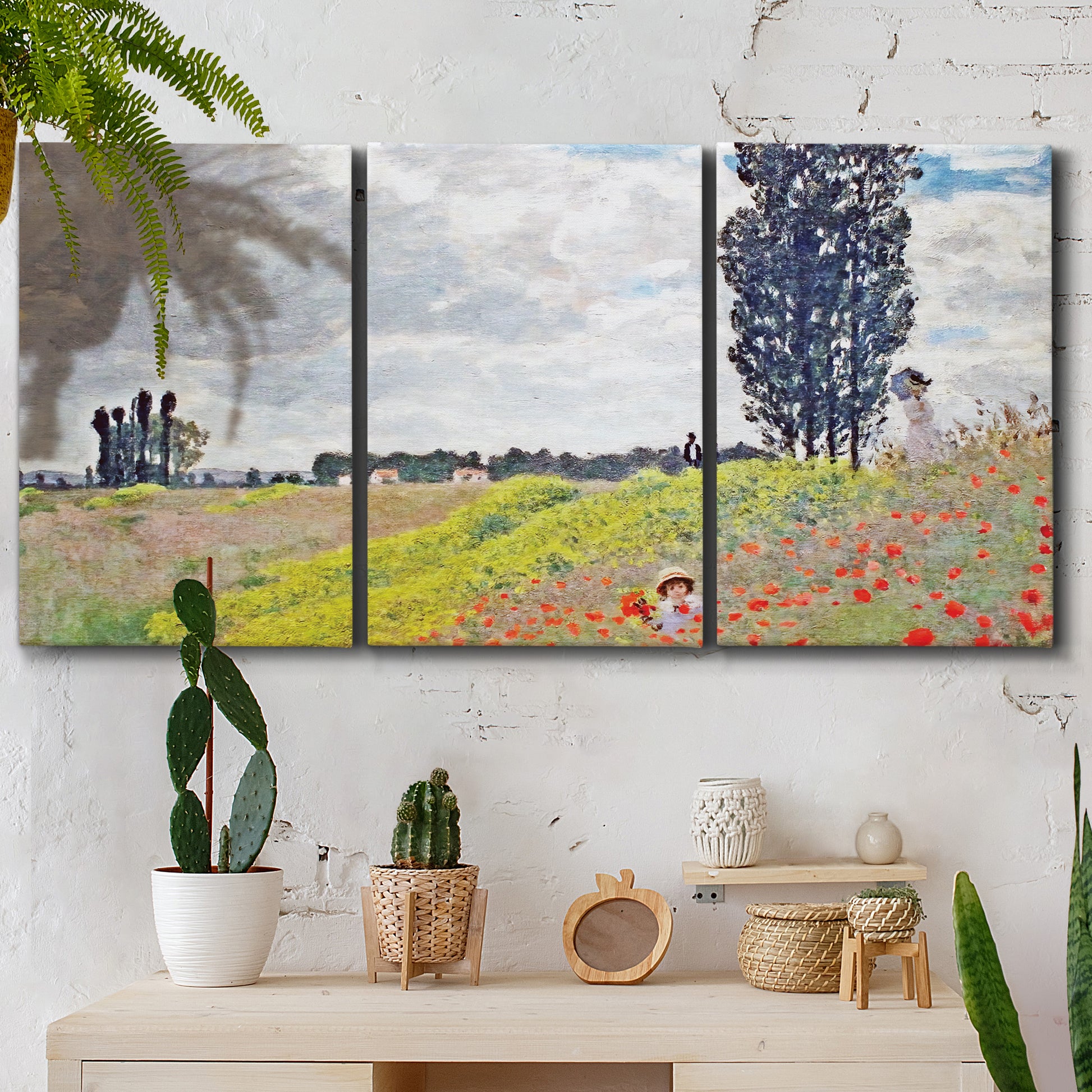 Three-panel canvas wall art featuring open poppy field in countryside, displayed in a boho-chic entryway above a console table.
