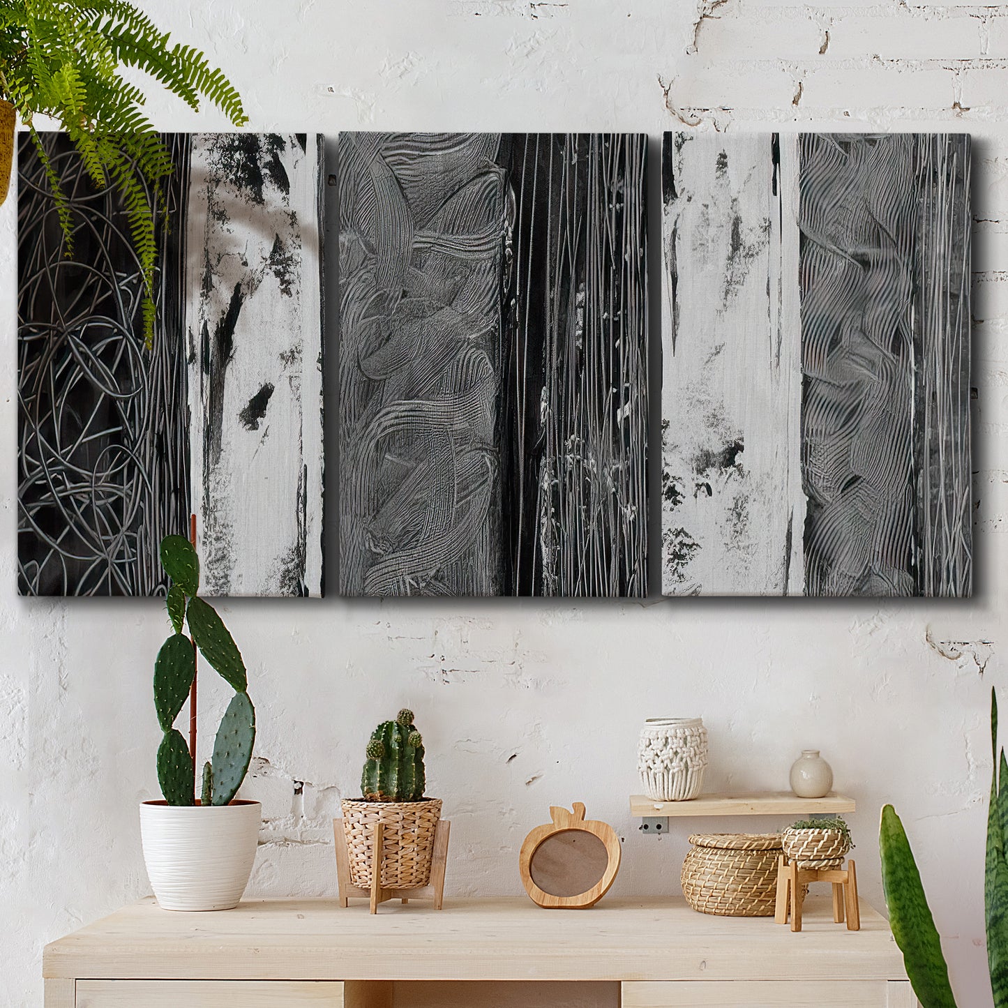 Three-panel canvas wall art featuring brushed metallic abstract textures, displayed in a boho-chic entryway above a console table.
