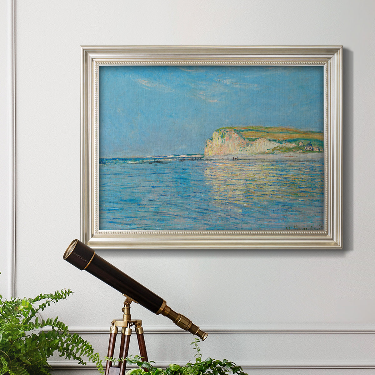 Impressionist coastal low-tide seascape at Pourville by Claude Monet in an ornate champagne frame displayed in a light-toned interior setting.