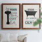 Set of two maple barnwood framed canvas prints depicting black tubs, hand-lettered phrases, and small teal accents arranged across two complementary compositions above a sofa in a bright living space.