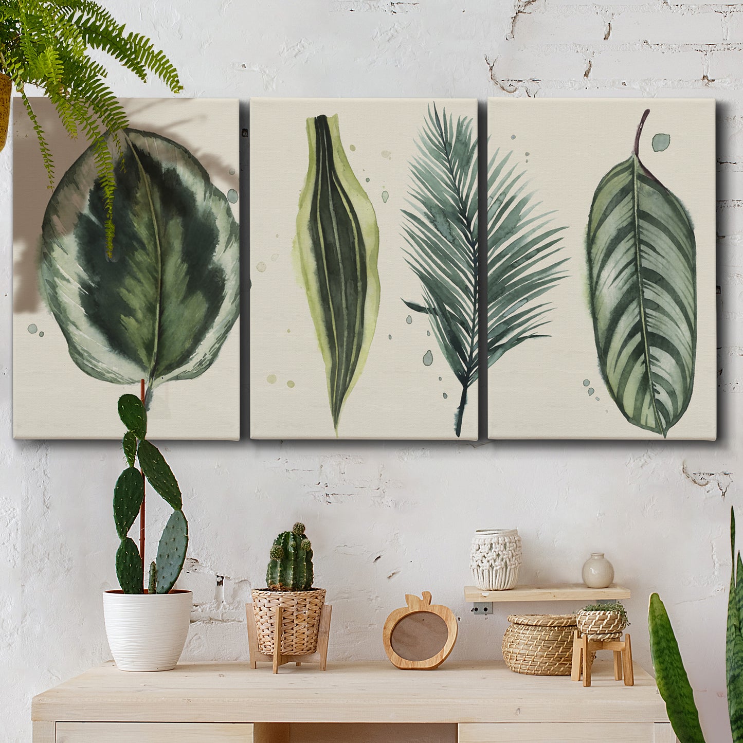 Three-panel canvas wall art featuring botanical palm leaf illustration, displayed in a boho-chic entryway above a console table.