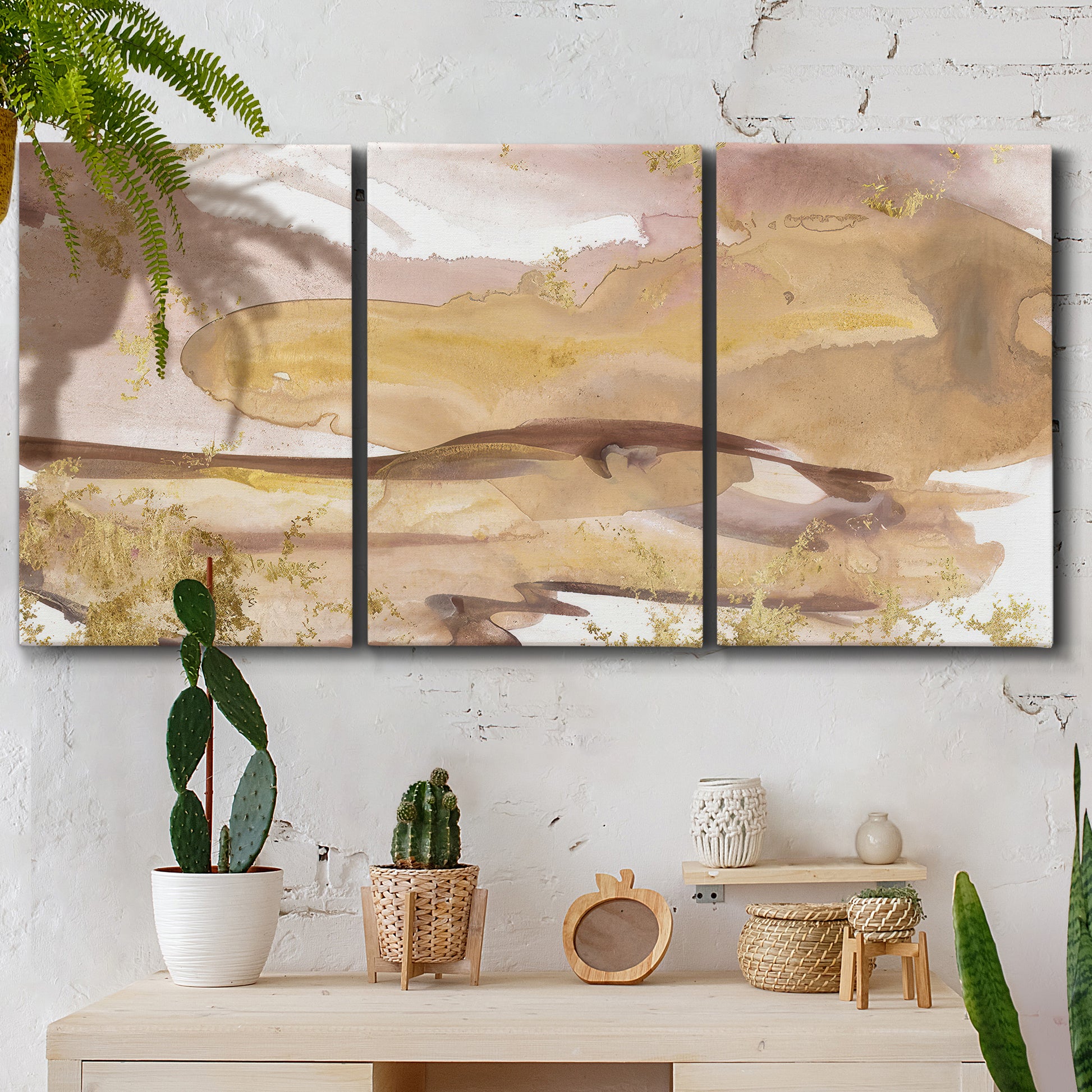 Three-panel canvas wall art featuring layered abstract dawn tones, displayed in a boho-chic entryway above a console table.