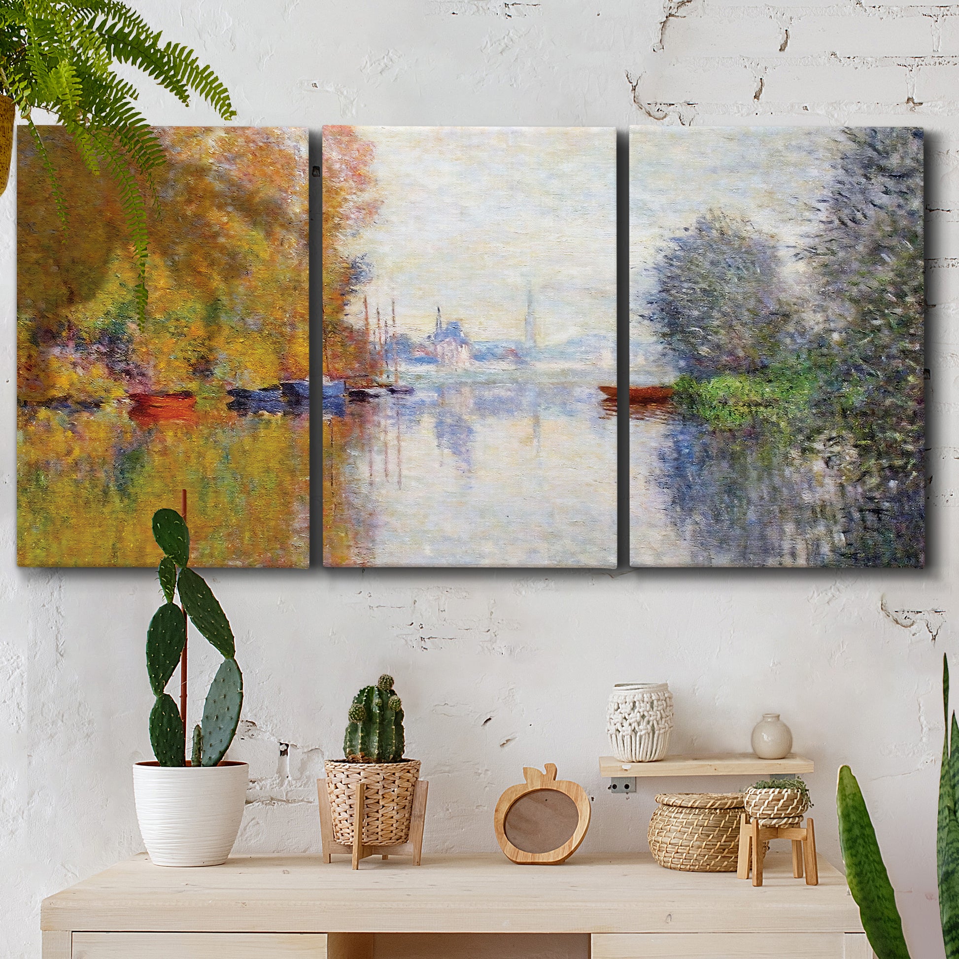 Three-panel canvas wall art featuring golden autumn light over riverside, displayed in a boho-chic entryway above a console table.