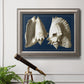 Vintage conch shell illustration on navy background in an ornate vintage silver frame displayed in a light-toned interior setting.