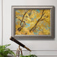 Vibrant yellow autumn leaves on branches in an ornate vintage silver frame displayed in a light-toned interior setting.